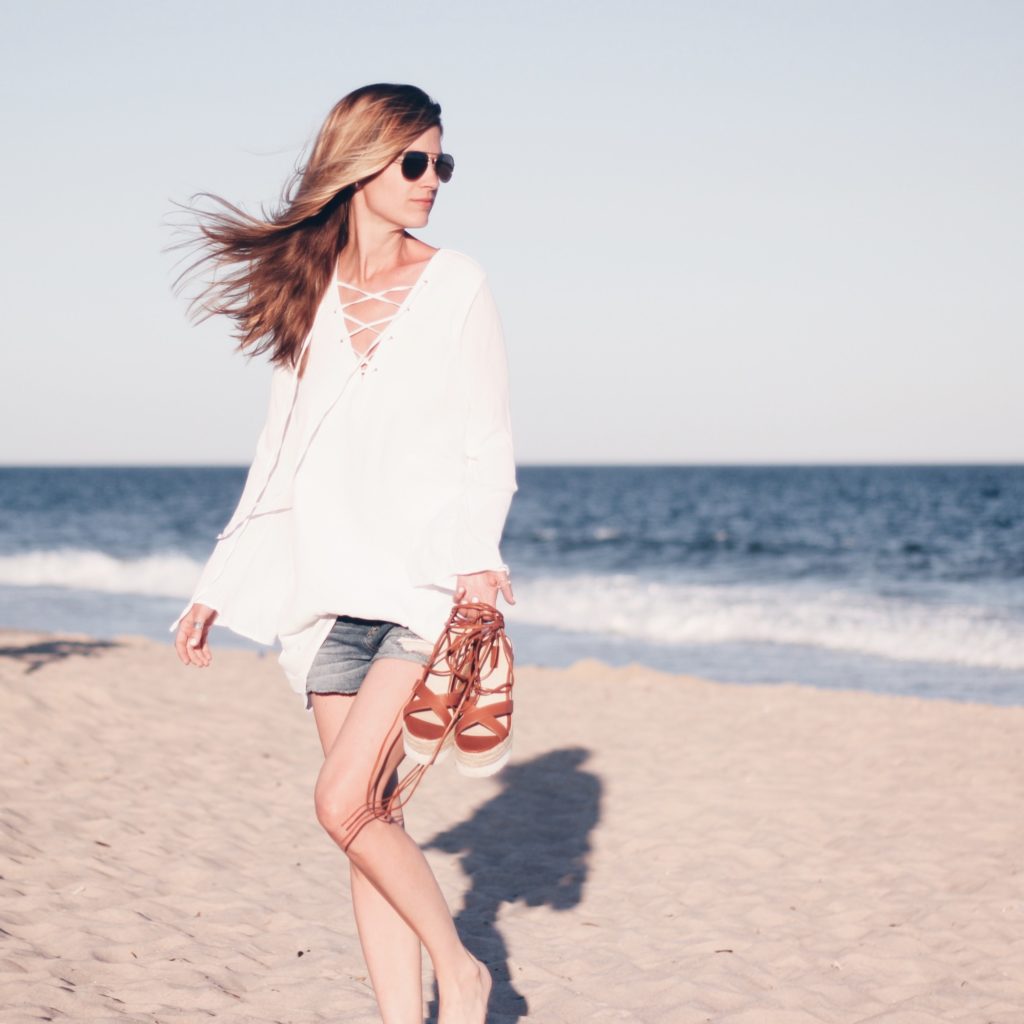 white bell sleeve lace-up top with denim cut off and flatform lace up sandals