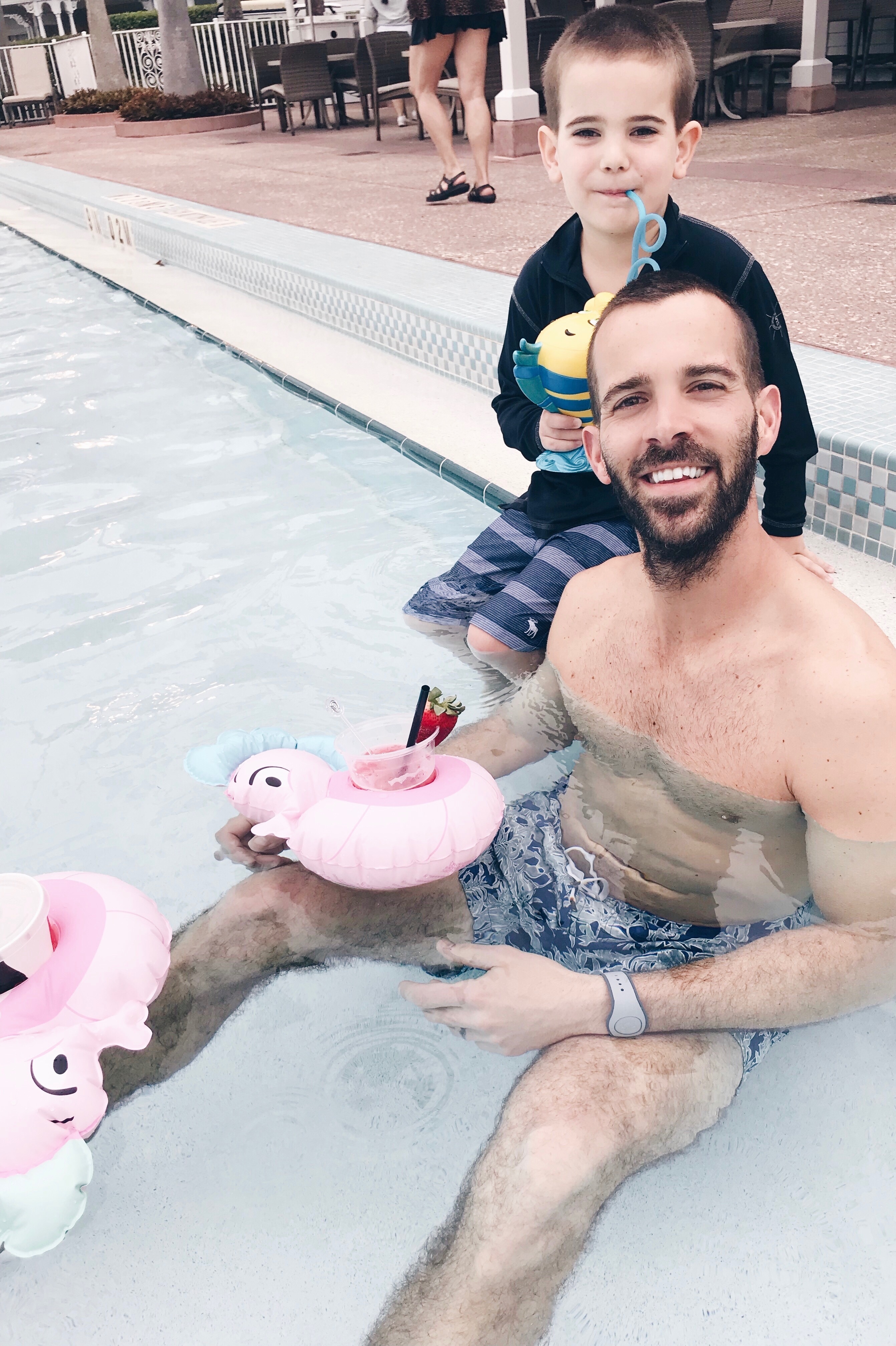 little mermaid pool party - father and son at floor using drink floats