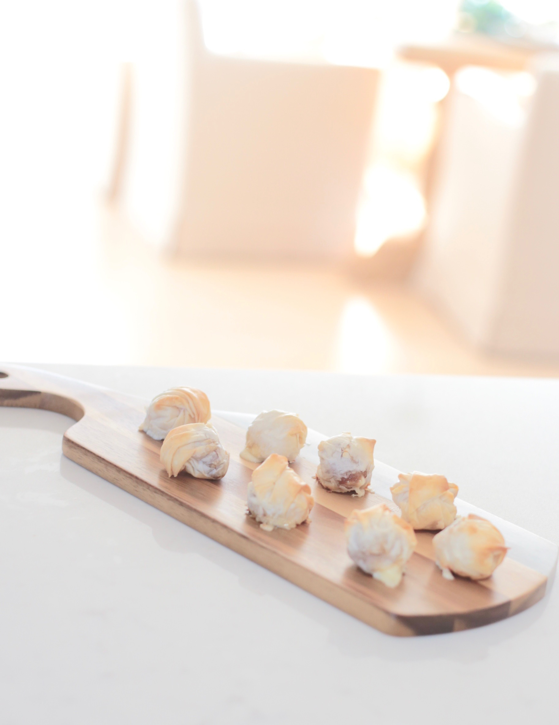 serve finger foods on a cutting board at a fun holiday party - pinteresting plans blog