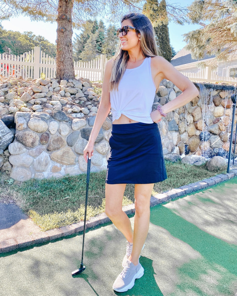 activewear summer outfit with knotted white tank and black skort on pinteresting plans blog